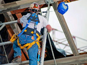Construction worker climbing ladder