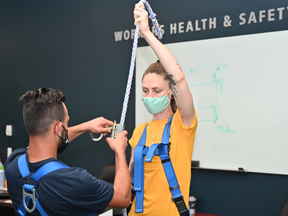 Instructor works with student during Working at Heights in-person training class