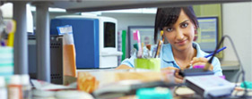 A woman sitting at an office desk learning about health and safety